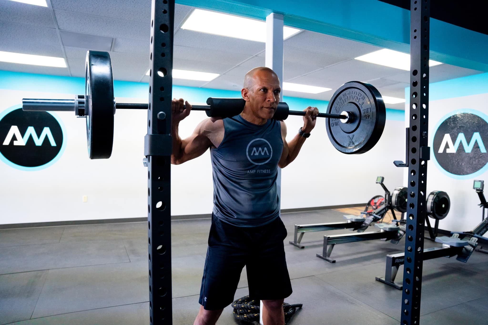 Coach leading a one-on-one personal training session at AMP Fitness in Mesa, AZ.